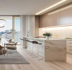 a modern kitchen and dining room with an ocean view