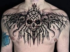 a man with tattoos on his chest is wearing an elaborate skull and cross tattoo design