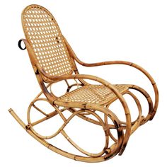 a wooden rocking chair with wicker seat and armrests on an isolated white background