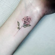 a small rose tattoo on the wrist