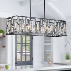 a chandelier hanging over a kitchen island