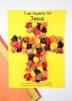 a cross made out of flowers sitting on top of a yellow card