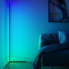 a living room with a couch and a blue light on the wall behind it,