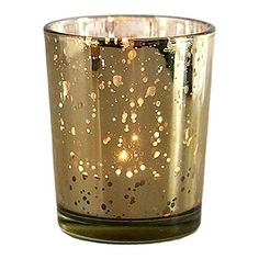 a candle that is sitting on top of a glass cup with some lights in it