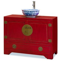 a red cabinet with a blue and white bowl on top