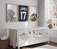 a baby's room is decorated in white and neutrals, with football posters above the crib