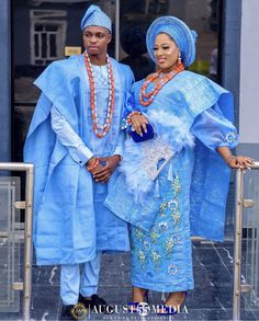 two people dressed in blue standing next to each other