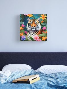 a tiger sitting on top of a bed next to flowers