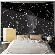 a bed sitting under a large wall mural in a bedroom next to a night sky filled with stars