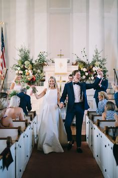 a bride and groom walk down the aisle after their wedding ceremony at st luke's church