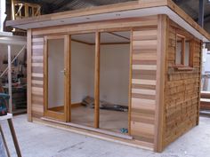 the inside of a small wooden building with sliding glass doors on it's side