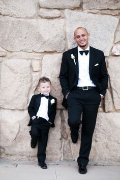 a man in a tuxedo poses with his son