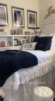 a white bed sitting in a bedroom next to two pictures on the wall above it