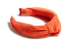 Add a pop of bold color to your fashion statement with our Knotted Terry Headband in Orange. This stylish accessory not only stands out with its vibrant hue but also offers a comfortable fit, making it the perfect choice for any occasion. Embrace the chic and trendy design of this headband adorned with a knotted top detail. It's all in the Details Color: Orange One size Cotton Made in China Vegan Bridal Candles, Barefoot Dreams Blanket, Tyler Candle Company, Golf Socks Women, Colorful Headbands, Knotted Top, Scout Bags, Knotted Headband, White Headband