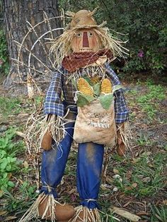 a scarecrow is standing in the grass