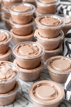 chocolate desserts in plastic cups sitting on a table