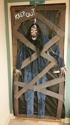 an image of a creepy scarecrow in the closet with tape wrapped around his body