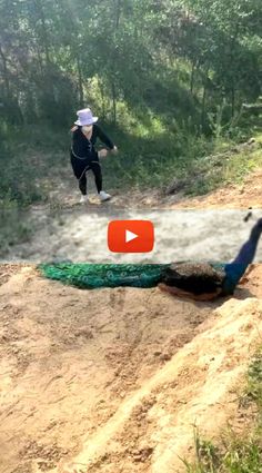 two people are walking down a dirt path with a peacock on the ground next to them