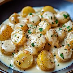 a white plate topped with potatoes covered in gravy