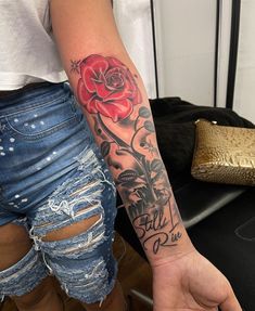 a woman with a rose tattoo on her arm