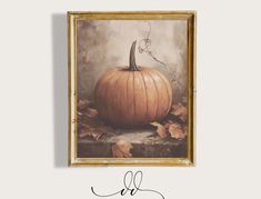 a painting of a pumpkin on display in a gold frame with the word fall written below it