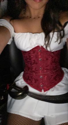 a woman wearing a red corset and white dress