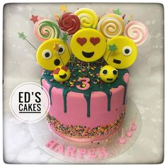 a birthday cake decorated with smiley faces and candies