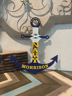 an anchor is hanging on the wall next to framed pictures