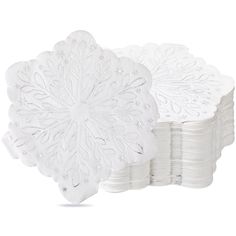 white paper napkins are stacked on top of each other in the shape of snowflakes