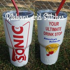 two cups with straws in them sitting on the grass