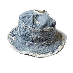 a blue denim hat with holes on the front and side, sitting against a white background