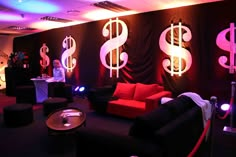 a room with couches, tables and lights on the walls that have dollar signs painted on them