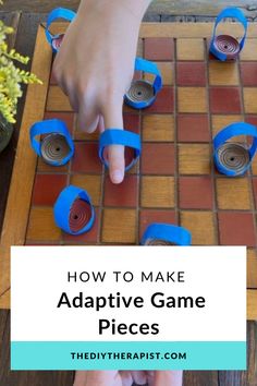 Picture shows a maroon and light brown checkers board with adapted game pieces.  Two hands are shown participating in the game with yellow flowers placed to the side. Adaptive Games, Adaptive Toys For Special Needs, Diy Assistive Technology, Homemade Adaptive Equipment, Adapted Games For Special Needs, Adapted Toys Occupational Therapy, Diy Adaptive Equipment Occupational Therapy Assistive Technology, Adaptive Equipment Occupational Therapy