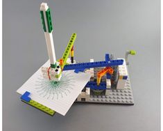 a lego model is shown with some construction tools on top of it, including a pen and ruler