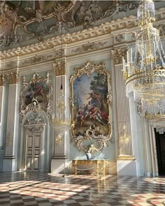 an ornate room with chandeliers and paintings on the walls