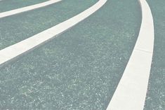 two white curved concrete steps in the grass