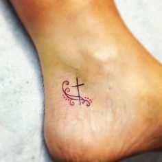 a person with a small tattoo on their foot that has the letter c in it