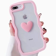 a woman holding up an iphone case with a heart on the front and back cover