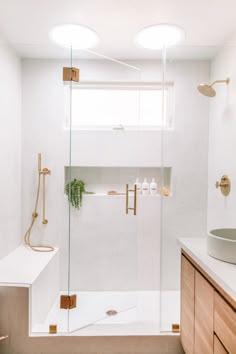 a bathroom with a shower, sink and mirror