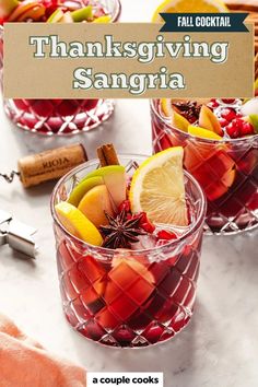 two glasses filled with fruit sitting on top of a table