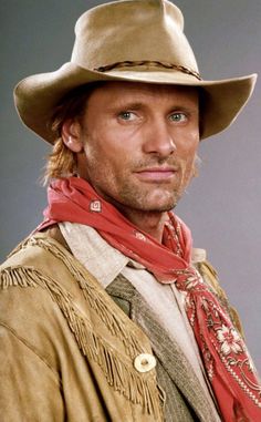 a man wearing a cowboy hat and scarf