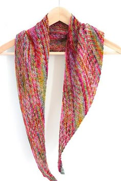 a multicolored scarf hanging on a wooden hanger