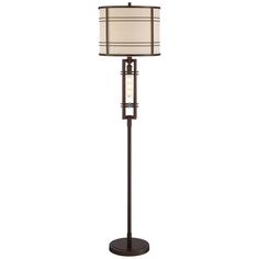 a floor lamp with a white shade on the top and a black base, in front of a white background