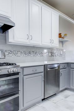 a kitchen with stainless steel appliances and white cabinets