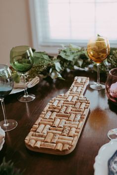 a wooden table topped with wine glasses and a keyboard