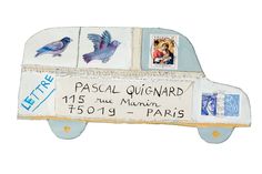 a small toy bus with stamps on the front and back sides, decorated with postcards