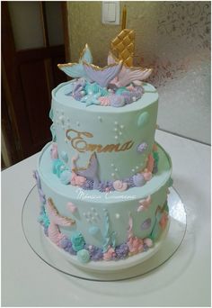 a three tiered cake decorated with butterflies and flowers