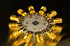 the top view of an electronic device with many gold knobs and screws on it