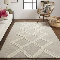 a living room with a white couch, chair and rug