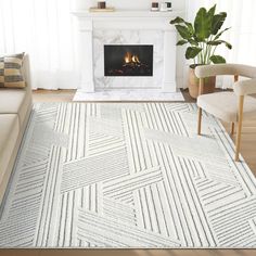 a living room area with a fireplace and white rugs on the hardwood flooring